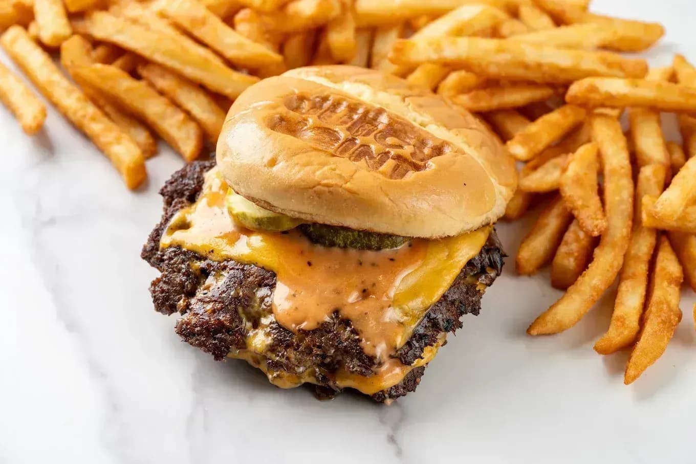 Halal smash burger with fries in Dallas TX - Juicy Joint